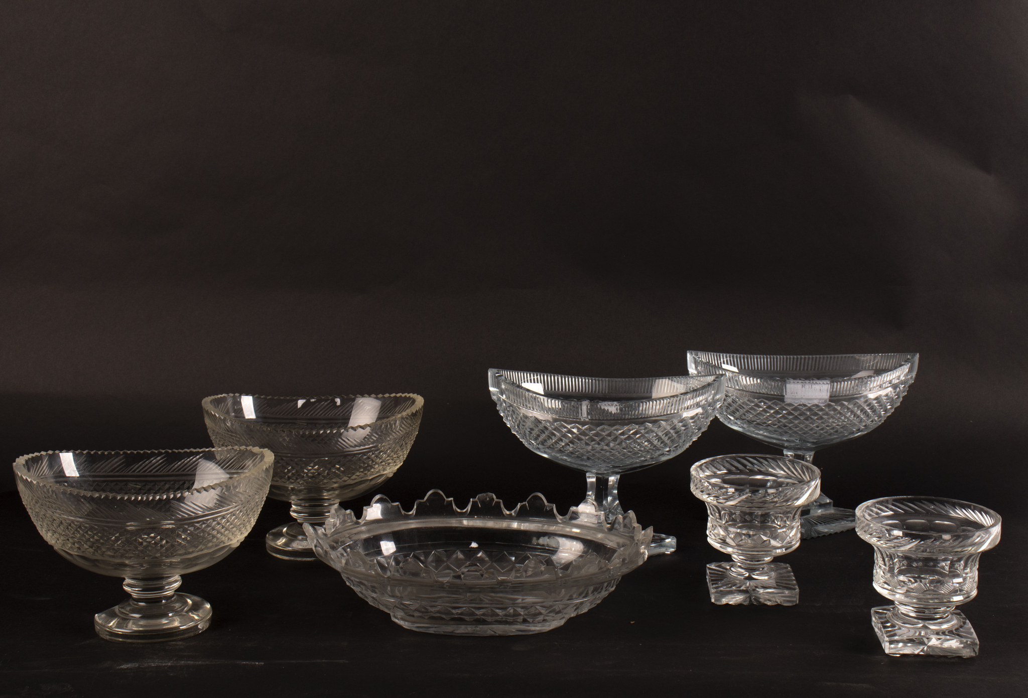 A pair of 19th Century cut glass comports of boat shape on diamond shaped feet,