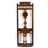 An Edwardian mahogany hall stand with central circular mirror set in pierced splat,