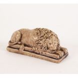 A brown glazed figure of a recumbent lion, on a rectangular base,