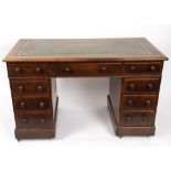 A mahogany kneehole desk fitted a surround of nine drawers,