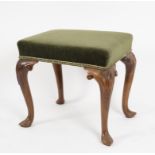 A 19th Century stained beech stool, on carved cabriole legs,