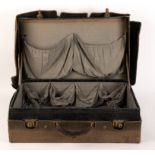 A crocodile skin suitcase and four parasols,