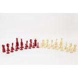 A 19th Century ivory and red stained ivory chess set, the kings 12.