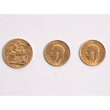 An Edward VII gold sovereign, 1910 (drilled) and two half sovereigns,