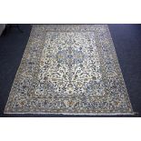 A Nain rug, the foliate field to a cream ground within a border of stylised leaves,