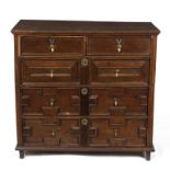 A Charles II oak chest, circa 1680, the four long drawers decorated with applied geometric moulding,