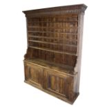 A 19th Century dresser with closed rack above cupboards,