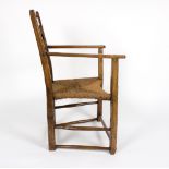 A primitive oak 18th Century chair with strung seat