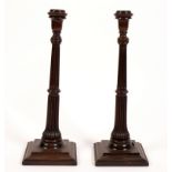 A pair of mahogany table lamps with fluted columns and square bases,