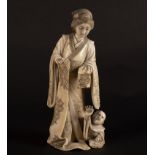A Japanese carved ivory figure of a Bijn and crawling child, Meiji period, signed,