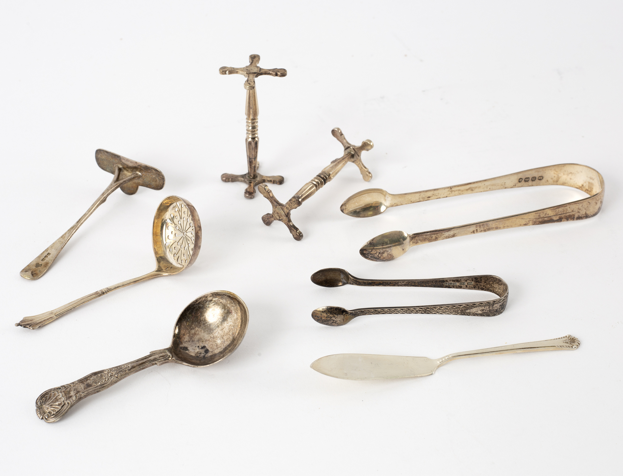 A pair of William IV silver knife rests, WK, London 1835, a Victorian caddy spoon, tongs etc.