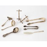 A pair of William IV silver knife rests, WK, London 1835, a Victorian caddy spoon, tongs etc.