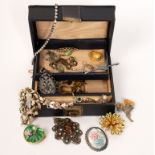 A quantity of costume jewellery including enamelled brooches, faux pearl necklace,