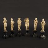 A Dieppe carved ivory band comprising six musicians, on ebonised socles, 16cm to 16.