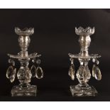 A pair of Regency cut glass table lights, hung prismatic drops on a square base,