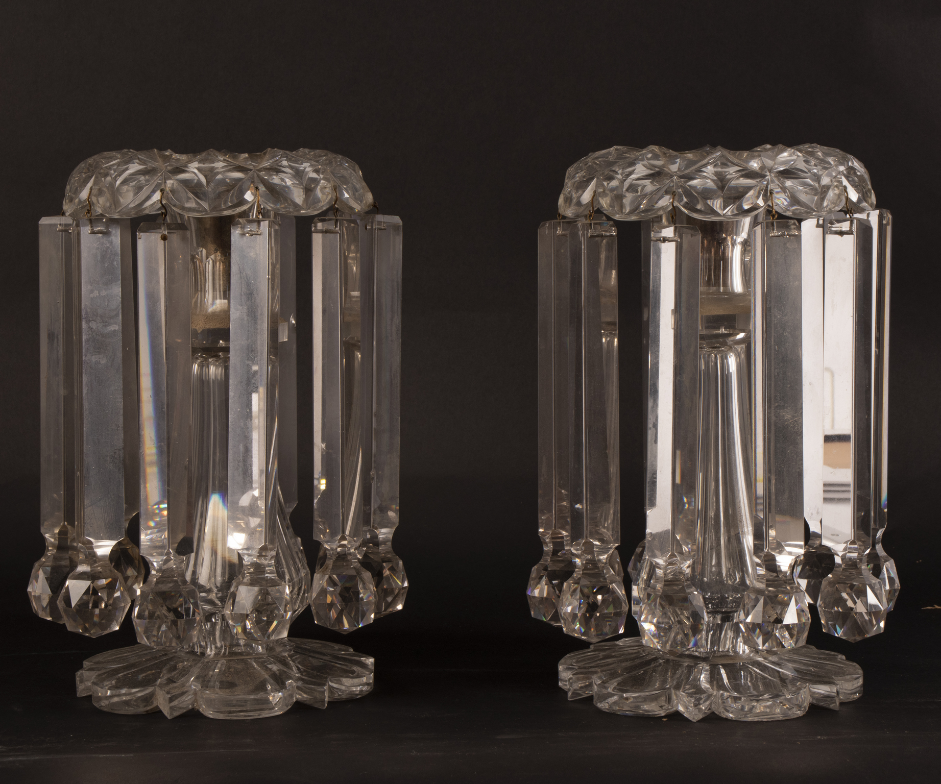 A pair of cut glass lustres hung with prismatic drops,