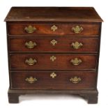 A George III mahogany chest of four long drawers on bracket feet,