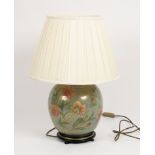 A large floral pottery table lamp with shade