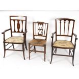 Two Edwardian mahogany elbow chairs with satinwood inlay and an Edwardian rush seated chair