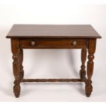 An oak table fitted a drawer on carved legs and stretchers,