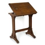 A Gothic revival oak adjustable reading stand, the hinged top with ratchet type support,