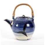 David Garland, a spherical teapot graduating glaze from blue to white with black designs,