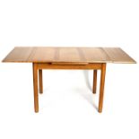 Gordon Russell, a mid 20th Century light oak extending dining table, on octagonal column legs,