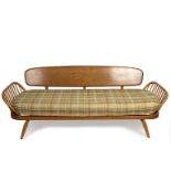 Ercol, a studio couch with solid panel back and slatted sides, bears Ercol sticker,