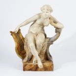 Goldscheider, a glazed terracotta figure of Psyche, seated holding a lyre, circa 1920,