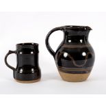 Ray Finch, Winchcombe Pottery, a tenmoku glazed jug with combed wave decoration, stamped,