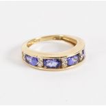 A tanzanite and diamond half hoop ring,