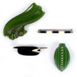 Two green Bakelite brooches of foliate form and two black and white pin brooches