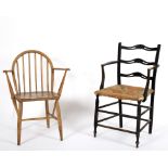 An Arts and Crafts style ebonised ladder back chair and an Ercol ash and elm Windsor chair