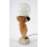 An Art Deco style lamp styled in alabaster as a pierrot balancing a globe on his back,