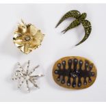 Sonia Rykiel, a swallow brooch, the pierced metal set green facetted stones,