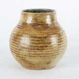 Peter Arnold, Alderney pottery, a ribbed squat vase in caramel lustre tones,