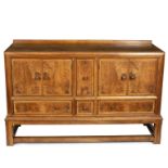 Heals, a walnut panelled sideboard, fitted two cupboards flanking a cellaret,