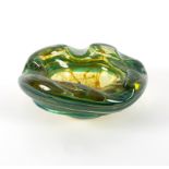 Mdina, a glass bowl of organic circular form in ochre trailed green glass,