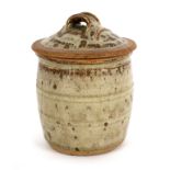 Richard Batterham (British, born 1936), a lidded jar with ash glaze and ribbed detail,