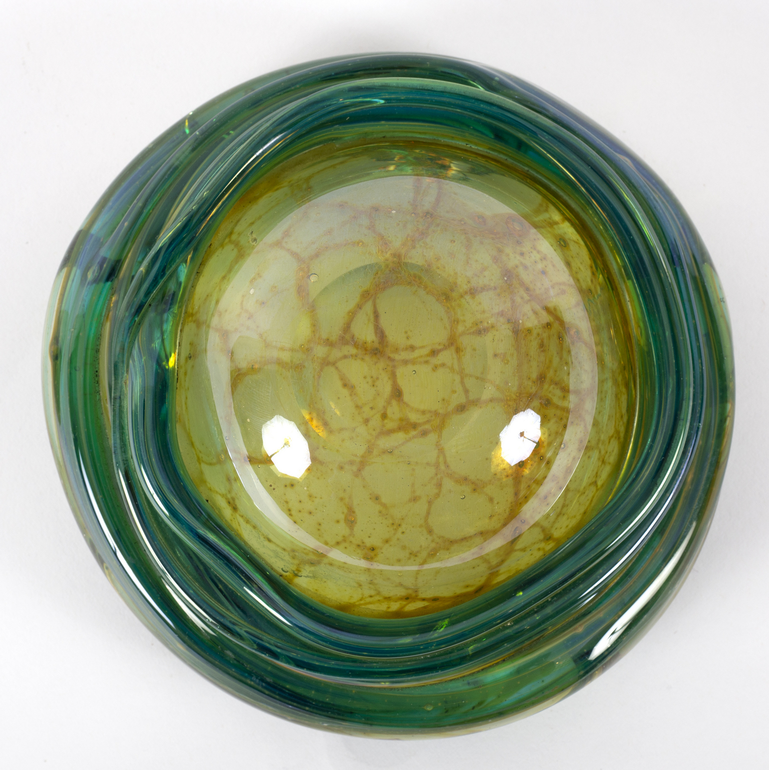 Mdina, a glass bowl of organic circular form in ochre trailed green glass, - Image 2 of 2