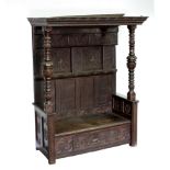 A 15th Century style carved oak canapé with baluster turned uprights and drawer beneath,