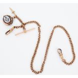 A 9ct rose gold Albert chain with clip to each end, T-bar, swivel fob and dagger charm,
