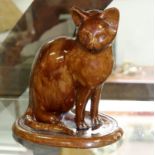 A mid 19th Century brown glazed pottery cat,