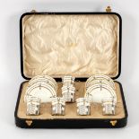 An Aynsley tea service of twelve pieces, the cups with silver mounts and handles,