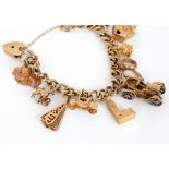 A 9ct gold charm bracelet hung with 9ct gold charms to include Big Ben and St Paul's,