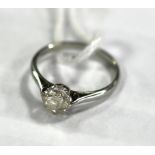 A diamond solitaire ring, the cushion cut stone claw set to a white precious metal shank,