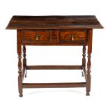 A rectangular oak table of Jacobean style, fitted a drawer on turned legs,