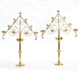 A pair of 19th Century Gothic revival brass candlesticks each with fleur-de-lys gallery drip pan