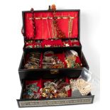 A large quantity of costume jewellery including amber necklaces, faux pearls, watches,