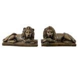 A pair of painted pottery recumbent lions on rectangular bases,